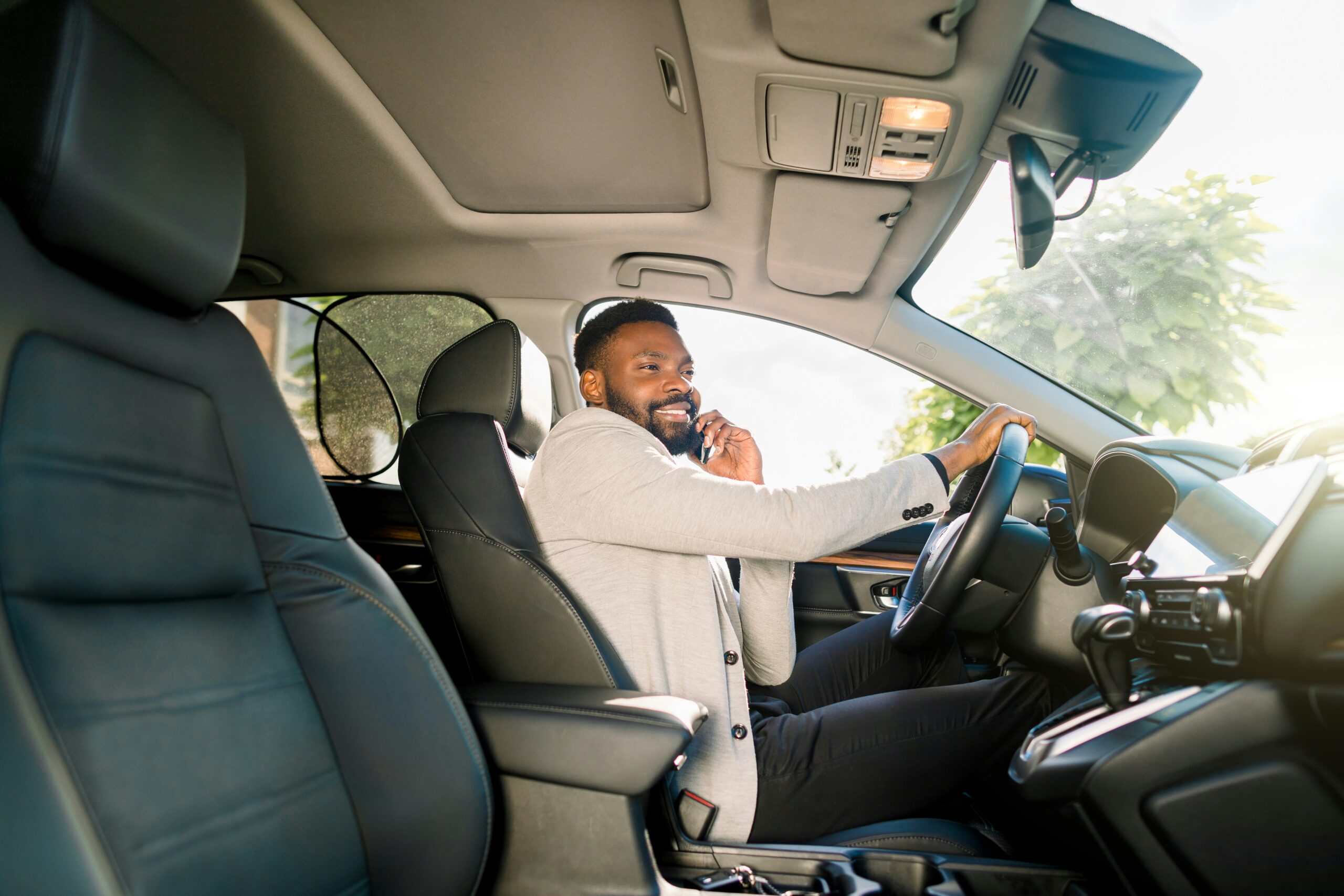 man using his phone while driving